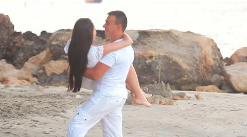Couple walking on beach. Young happy interracial couple walking on beach Stock Footage 53081853