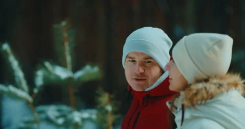 Couple walking in beautiful pine forest in winter, portrait of loving people 스톡 동영상 234440761