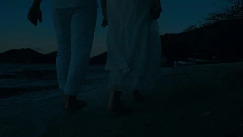 Couple walking in the dark at the beach Stock Footage 117280754