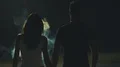 The couple walking in the dark street through a white smoke. slow motion 4k or 4k+ Resolution