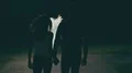 The couple walking in the dark street through a white smoke. slow motion 4k or 4k+ Resolution