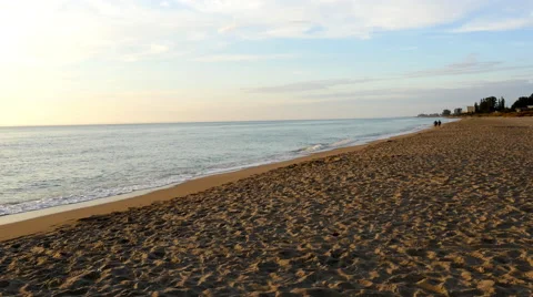 Couple walking in distance on empty beach, 4K Stock Footage 47336540