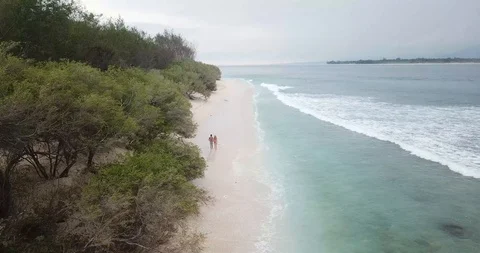 Couple Walking Down Bali Secluded Beach Video stock 106236596