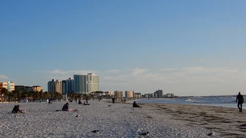 Couple Walking Down Beach At Sunset With Hotels On Beach Resort Vacation Vil Stock Footage 127250497