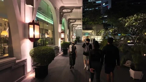 A couple walking down a sidewalk in front of a building Video stock 318090227