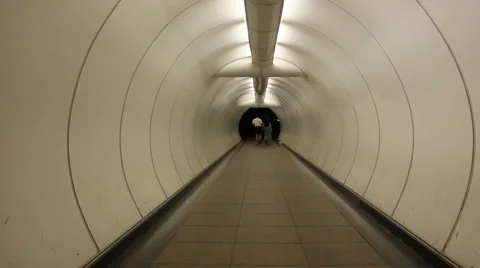 Couple Walking Down Tunnel Stock-Footage 1086753