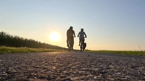 Couple Walking with E-Bikes at Sunset on  Road Stock Footage 334063449