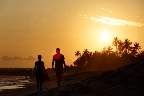 Couple walking evening beach Stock Photos