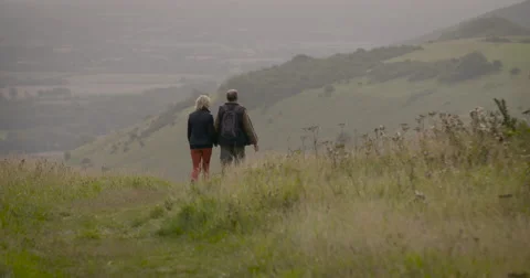 Couple walking in field Stock Footage 59899559