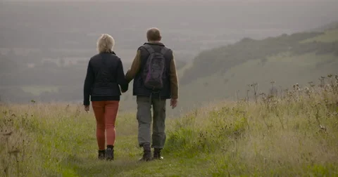 Couple walking in field Stock Footage 59899562