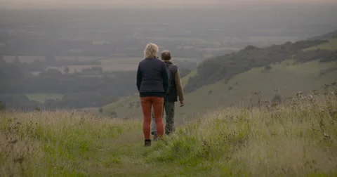Couple walking in field Stock Footage 59899583