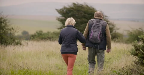 Couple walking in field Stock Footage 59899598