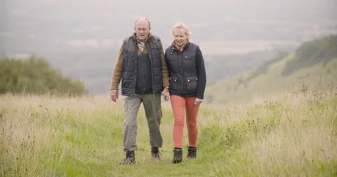 Couple walking in field Stock Footage 59899626