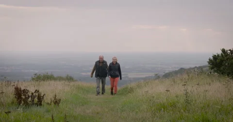 Couple walking in field Stock Footage 59899638