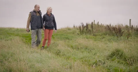 Couple walking in field Stock Footage 59899666