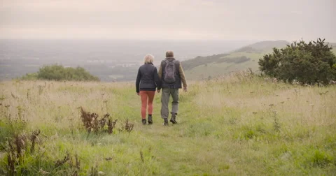 Couple walking in field Stock Footage 59899686