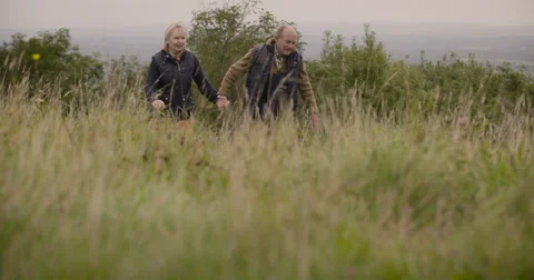 Couple walking in field Stock Footage 59899707