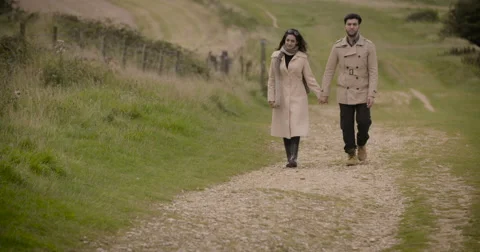 Couple walking in field Stock Footage 59899893