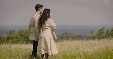 Couple walking in field Stock Footage 59899896