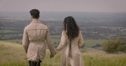 Couple walking in field Stock Footage 59899908