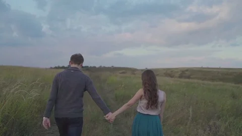 Couple walking in a field Stock-Footage 72635276