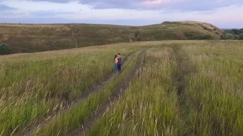 Couple walking in a field Stock Footage 72636138