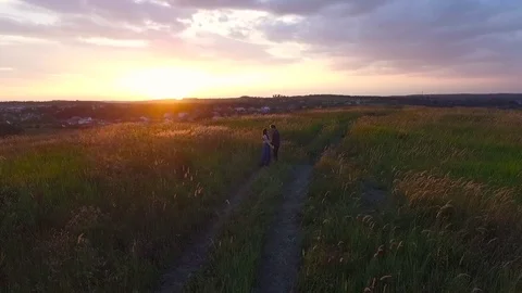 Couple walking in a field Stock Footage 72636267