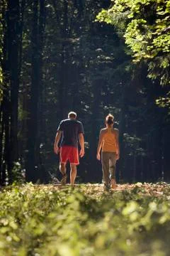 Couple walking in forest Stock Photos