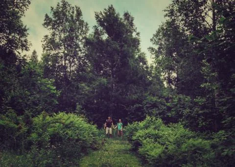 Couple walking in the forest Stock Photos