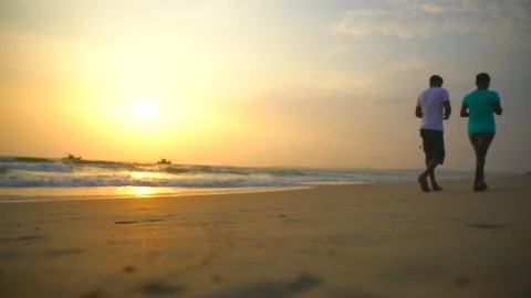Couple walking in goa beach at sun set time Stock Footage 216532169