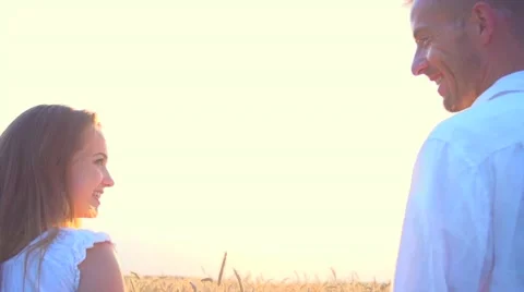 Couple walking on golden wheat field and holding each other's hands over sunset Stock Footage 59082016