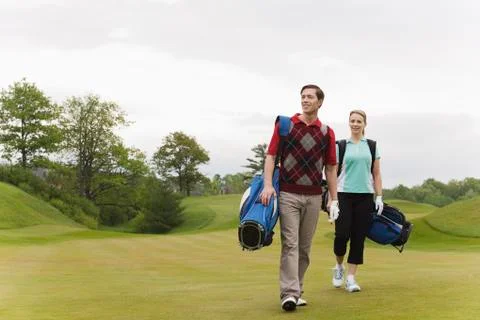 Couple Walking on Golf Course Fotos de archivo