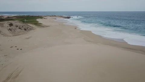Couple Walking Hand in Hand on Cabo Mexico Beach, Arial Drone Stock Footage 99150133