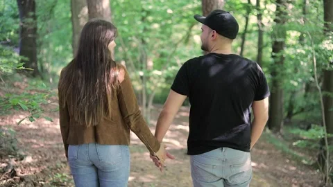 Couple Walking Hand In Hand in the forest, blurry Stock Footage 131627240