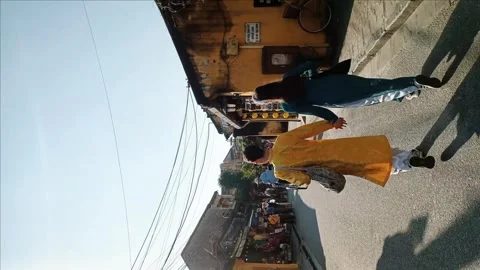 Couple walking hand in hand with their traditional Vietnamese ao dai 스톡 동영상 248554349