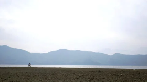 Couple walking the lakeside Stock Footage 50142965