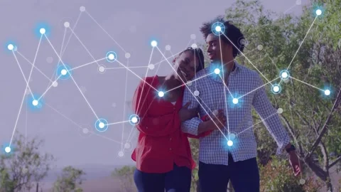 Couple walking linked arms along rural path, nodes fading left, overlapping Video stock 333657583
