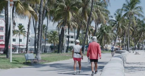 Couple walking in miami beach Stock Footage 204874690