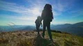 The couple walking on the mountain on a sunny background. slow motion 4k or 4k+ Resolution