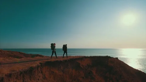 The couple walking on the mountain on a sunset background Stock-Footage 151326300