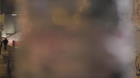 Couple walking next to Berlin wall at night Stock-Footage 67986385
