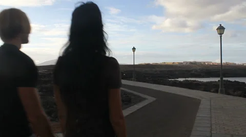 Couple walking by the ocean Stock Footage 37892670