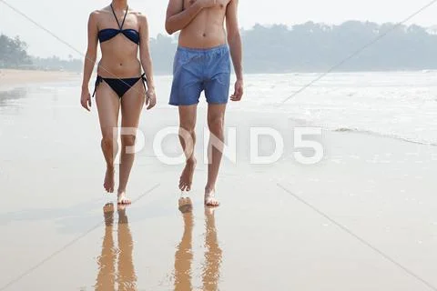 Couple Walking By The Ocean