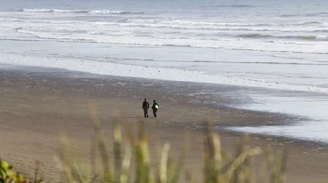 Couple walking out of frame on the beach 스톡 동영상 53266679