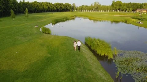 Couple Walking Outdoors Near River Aerial View, Young Man And Woman Holding Stock Footage