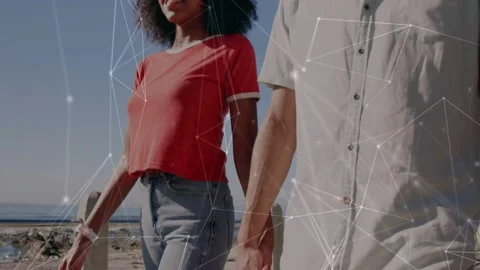 Couple walking on path sharing moment, camera panning up revealing tech network Stock Footage 333064369