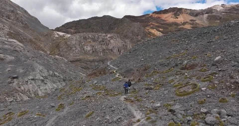 A couple walking in a path through a mountainous landscape Video stock 251207887