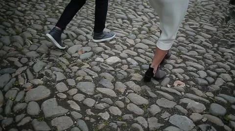 Couple walking on the pavement legs view Stock Footage 64775619
