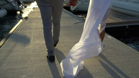 Couple walking on pier Stock Footage 81043650