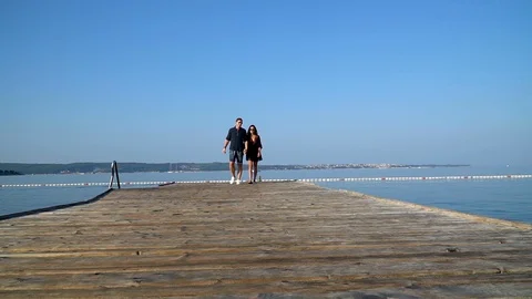 A couple walking on a pier Stock Footage 95083190